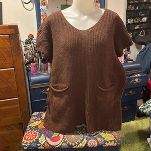 Brown knit tunic with front pockets.